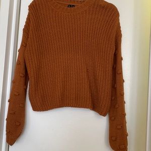 Cropped cable knit sweater